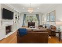 Bright living room featuring hardwood floors, a fireplace, and a comfortable seating area at 582 Lakeshore Ne Dr, Atlanta, GA 30307