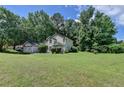 Charming traditional home with a two-car garage and lush surrounding trees at 1464 Yorktown Nw Dr, Lawrenceville, GA 30043