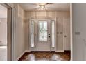 Foyer with decorative glass front door, sidelights, tile floor, and neutral paint at 1464 Yorktown Nw Dr, Lawrenceville, GA 30043
