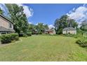 Expansive front yard with a view of surrounding homes in a quiet neighborhood at 1464 Yorktown Nw Dr, Lawrenceville, GA 30043