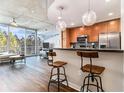 Bright open-concept living space with floor-to-ceiling windows and concrete ceilings at 3300 Windy Ridge Se Pkwy # 718, Atlanta, GA 30339