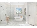 Modern bathroom features a soaking tub, glass-enclosed shower, and stylish fixtures at 1967 Mason Mill Rd, Decatur, GA 30033
