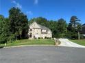 Attractive home with a long driveway, lush lawn, and mature trees offering privacy and curb appeal at 3152 Meadow Glade Ct, Lithonia, GA 30038
