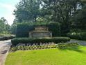 Dunwoody Springs community sign surrounded by flowers and manicured green shrubs at 41 Basswood Cir, Sandy Springs, GA 30328