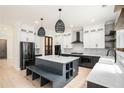 Modern kitchen with stainless appliances, white cabinets, and a center island with seating at 4276 Lindsey Ne Way, Roswell, GA 30075