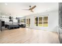 Open living room with hardwood floors, a ceiling fan, and a modern kitchen with stainless appliances at 4276 Lindsey Ne Way, Roswell, GA 30075