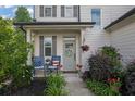 Inviting front porch with charming seating and decorative plants create curb appeal at 779 Sanders Rd, Cumming, GA 30041