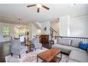 Spacious living room with hardwood floors, elegant furniture, and seamless flow to dining area at 1188 Parktown Dr, Mableton, GA 30126