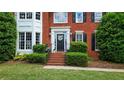 Charming home entrance with a black front door and elegant landscaping at 2005 Sweetgum Trl, Cumming, GA 30041