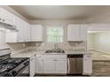Bright kitchen with white cabinets, laminate countertops, and stainless appliances at 5786 Longbow Dr, Stone Mountain, GA 30087