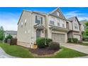 Side view of a beautiful two-story townhome with a two-car garage and well-maintained landscaping at 5830 Keystone Pt, Lithonia, GA 30058