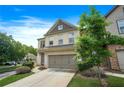 Attractive two-story townhome with a two-car garage, well-kept lawn, and mature trees at 5830 Keystone Pt, Lithonia, GA 30058