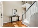 Elegant foyer with hardwood floors, staircase, and stylish console table, creating a welcoming entrance at 963 Hawk Creek Trl, Lawrenceville, GA 30043