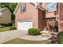 Well-kept red brick home with a two-car garage, landscaped front yard, and a traditional architectural style at 963 Hawk Creek Trl, Lawrenceville, GA 30043