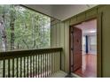 View of balcony with wooded view and freshly painted door leading to living room at 1015 Dunbar Dr, Dunwoody, GA 30338