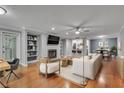 Inviting living room with hardwood floors, fireplace, and open view to dining area at 1015 Dunbar Dr, Dunwoody, GA 30338