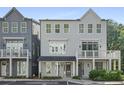 Charming three-story home boasting double balconies, neutral paint, manicured landscaping, and a welcoming entrance at 3 Becker Nw Pl, Atlanta, GA 30307
