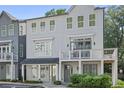 Charming, light blue, two-story townhome with a balcony and beautiful landscaping in front of it at 3 Becker Nw Pl, Atlanta, GA 30307