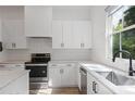 Modern kitchen with stainless steel appliances, undermount sink, and bright white cabinetry at 3 Becker Nw Pl, Atlanta, GA 30307