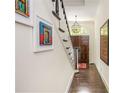Foyer features hardwood floors, staircase and art, providing an inviting entrance at 3182 Windsor Lake Ne Dr, Atlanta, GA 30319
