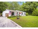 Charming one-story home with a spacious, well-maintained front lawn and a welcoming, decorated porch at 3184 Newcastle Way, Snellville, GA 30039