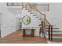 Bright foyer with wood floors, staircase, and stylish decor, enhanced by natural light at 605 Buttercup Trce, Johns Creek, GA 30022