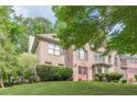 Traditional brick home with manicured lawn, mature trees, arched window and covered entry providing great curb appeal at 709 Eastwood Rise, Stone Mountain, GA 30087