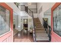 Bright foyer with hardwood floors, high ceilings, staircase, and glass paneled entry doors providing an inviting entrance at 709 Eastwood Rise, Stone Mountain, GA 30087