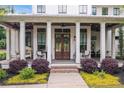 Inviting front porch with comfortable seating and stylish decor of the home at 201 Dobbs Rd, Woodstock, GA 30188