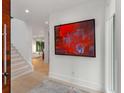 Bright entryway with a view to stairs, a view to the living room, and red modern art at 2385 Nesbitt Dr, Brookhaven, GA 30319