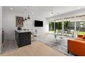 Open concept living space with modern fixtures and a view to a patio and backyard at 2385 Nesbitt Dr, Brookhaven, GA 30319