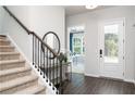 Inviting foyer featuring wood floors and staircase leading to the upper level at 3062 Cambridge Mill St, Acworth, GA 30102
