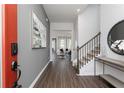 Elegant foyer featuring wood floors, gray walls, and staircase leading to the upper level at 3062 Cambridge Mill St, Acworth, GA 30102