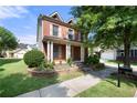 Attractive brick home with a manicured lawn and mature tree, highlighting the property's charming exterior and curb appeal at 3826 Baxley Village Trl, Suwanee, GA 30024