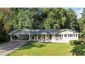 Charming single-story home with a well-maintained lawn and a covered carport at 4353 White Oak Dr, Sugar Hill, GA 30518