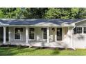 Inviting front porch with hanging plants and a welcoming entryway at 4353 White Oak Dr, Sugar Hill, GA 30518