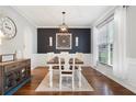 Formal dining room with modern lighting fixture, hardwood floors, and elegant decor at 101 Misty Valley Dr, Canton, GA 30114