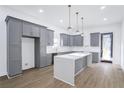 Bright kitchen featuring grey cabinets, light countertops, and an island with pendant lighting at 262 Crumley St Sw, Atlanta, GA 30312