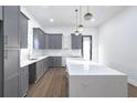 Kitchen with grey cabinets, white countertops, an island and stainless steel appliances at 262 Crumley St Sw, Atlanta, GA 30312