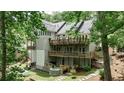 Multi-level decks and a hot tub enhance this home's serene backyard oasis with mature trees and landscaping at 2682 Boulder Creek Ne Dr, Roswell, GA 30075