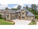 Exterior of a two-story home with a three car garage and well-maintained landscaping at 407 Estates View Dr, Acworth, GA 30101