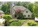 Charming two-story home with a stone chimney and a beautifully landscaped front yard at 4101 Rickenbacker Ne Dr, Atlanta, GA 30342