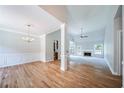 Bright living room showcasing hardwood floors, fireplace, and large windows allowing ample natural light at 1480 Holly Brook Rd, Snellville, GA 30078