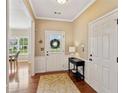 Inviting entryway with hardwood floors, a decorative rug, and a view into the dining area at 3365 Buffington Ln, Cumming, GA 30040