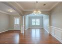 Spacious living room with hardwood floors, designer paint and archways offering architectural interest at 3399 Lake Frg, Fairburn, GA 30213