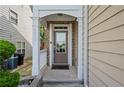 Inviting front entrance with a covered porch and classic door at 5880 Crestwick Way, Cumming, GA 30040