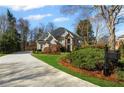 Charming home featuring a manicured lawn, mature landscaping, and a private driveway, offering curb appeal at 2502 Oak Hill Ovlk, Duluth, GA 30097