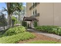 Charming building entrance features a canopy and well-maintained landscaping at 395 Pharr Ne Rd # 103, Atlanta, GA 30305