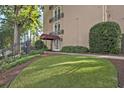 Beautiful building exterior, a covered entrance, and lush green landscaping create an inviting curb appeal at 395 Pharr Ne Rd # 103, Atlanta, GA 30305