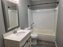 Bathroom featuring a tub/shower combo, new vanity, and gray walls at 5818 Par Four Ct, Lithonia, GA 30038